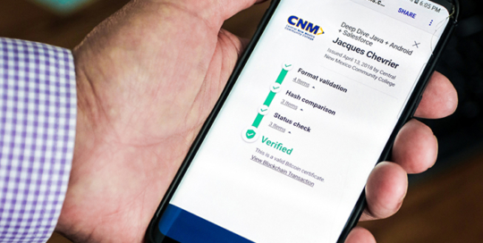 Bill Day 1 cropped hand holding phone with blockchain certificate